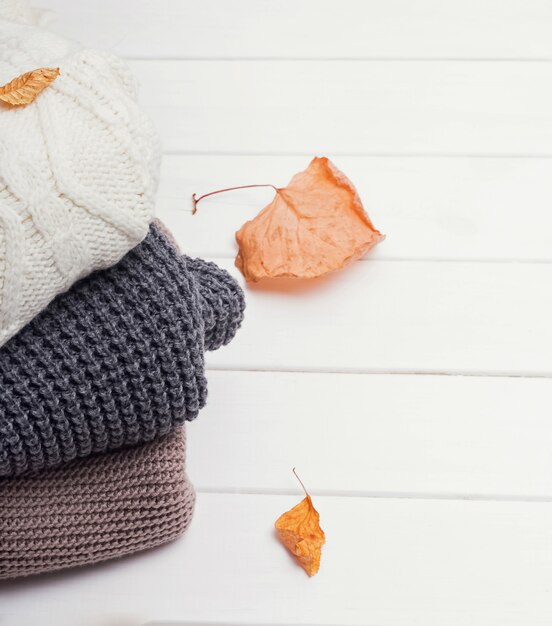 Close up warm knitted sweaters in stack