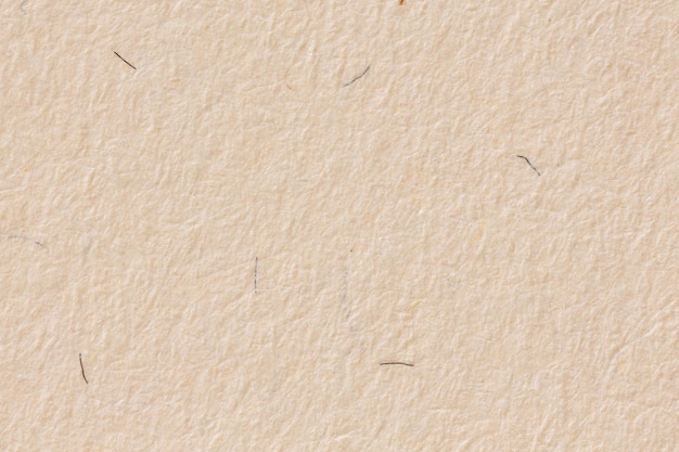 Close up of warmtoned offwhite paper background