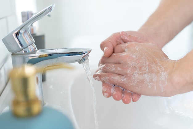 Close-up washing hands in the sink