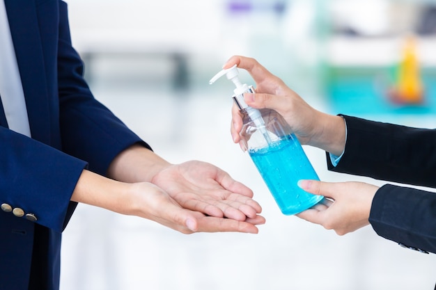 Close-up washing hands with alcohol gel or antibacterial soap sanitizer . Hygiene concept. prevent the spread of germs and bacteria and avoid infections corona virus [Covid-19]