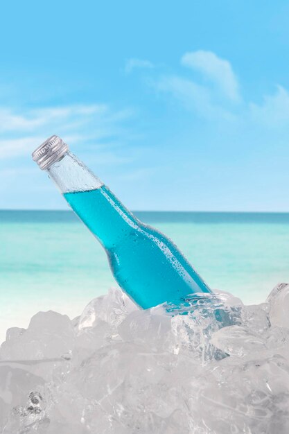 Photo close-up of water bottle against blue sea and sky