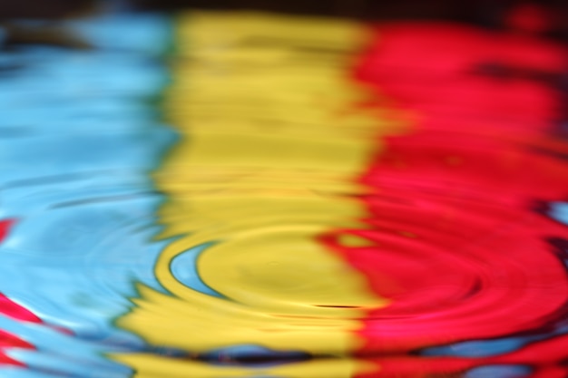 Photo close up of a water drop falling and impact with a body of water