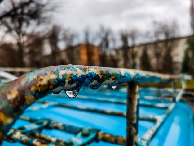 Close-up of water drops on metal railing