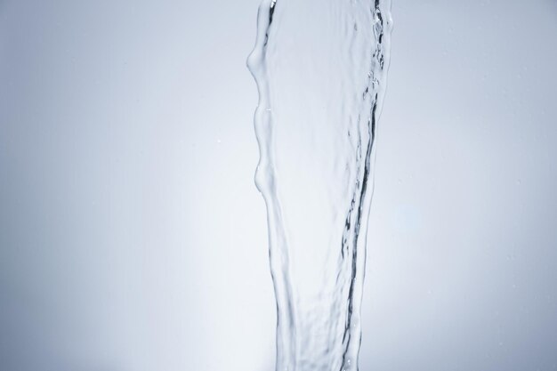 Close-up of water falling against gray background