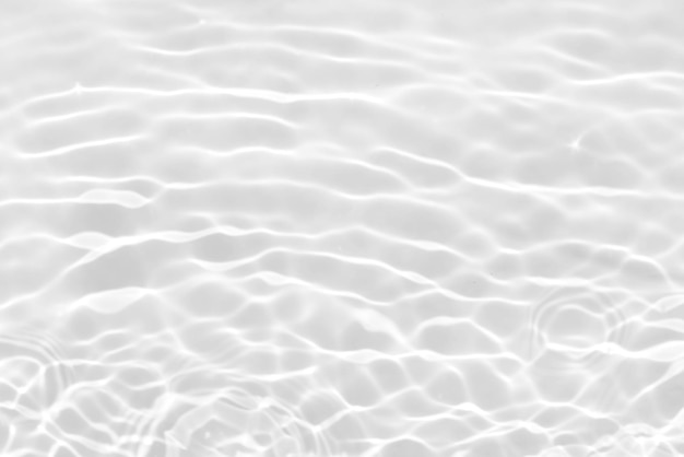 A close up of the water's surface with a white background.