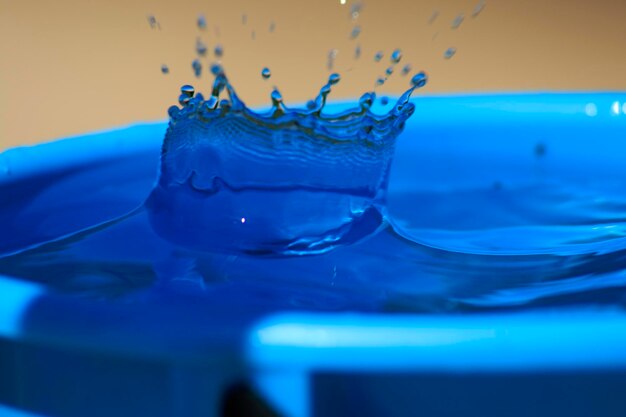 Close-up of water splashing against blue background