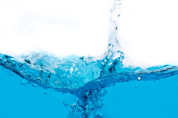 Close-up of water splashing against blue background