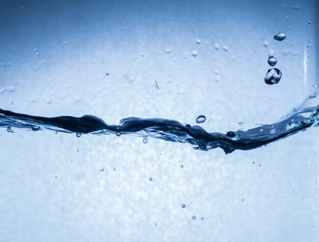 Close-up of water splashing against blue background