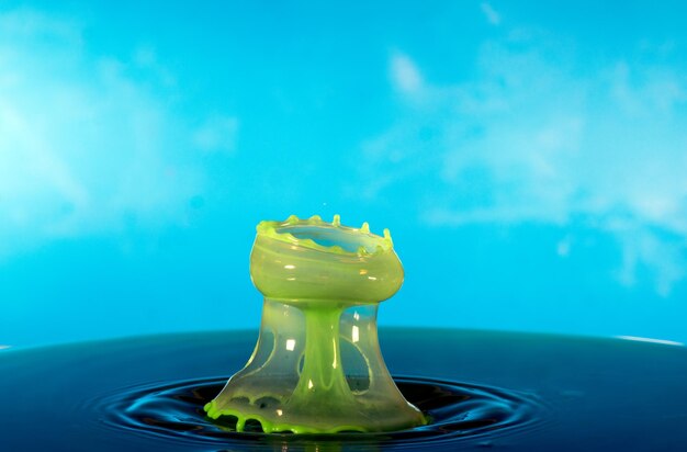 Close-up of water on table against blue sky