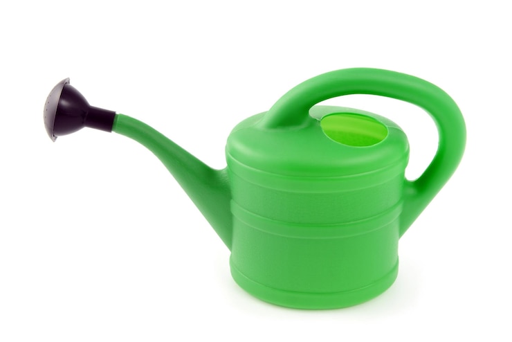 Photo close-up of watering can against white background
