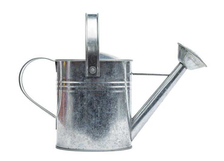 Photo close-up of watering can against white background