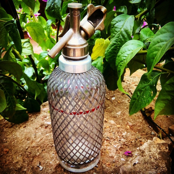 फोटो close-up of watering can by plants in garden