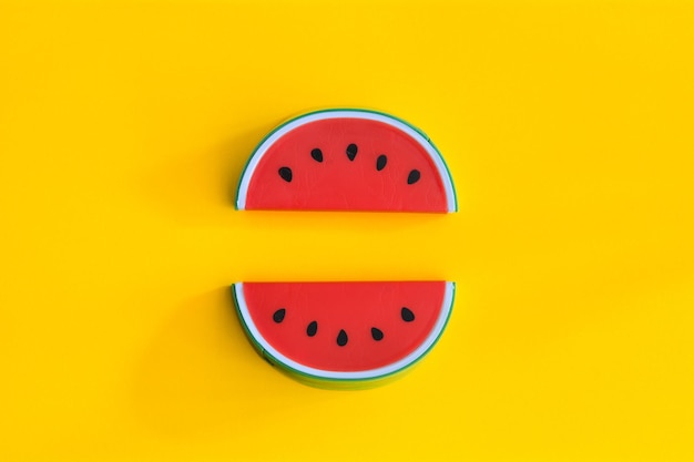 Photo close-up of watermelon toy over yellow background