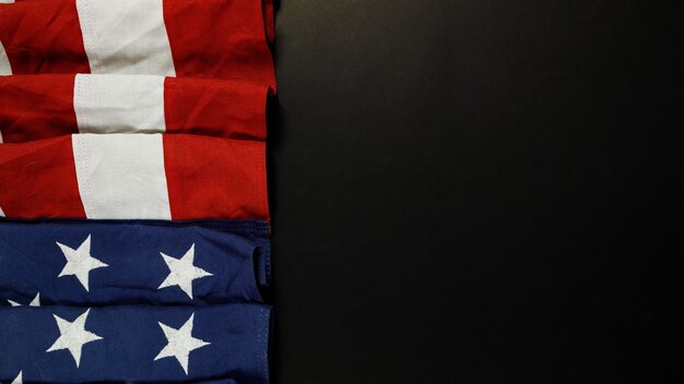 Close up of waving national usa american flag on black background with copy space for text.