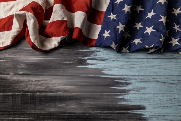 Close up of waving national usa american flag on wooden background with copy space for text.