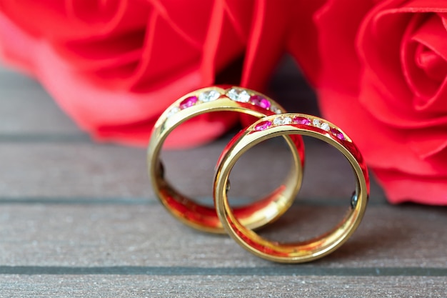 Close up wedding ring and red rose