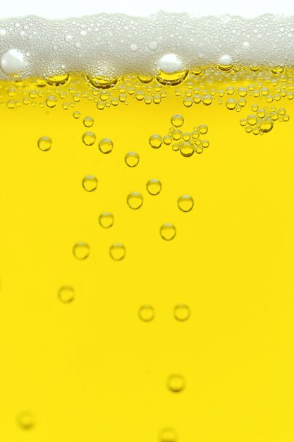 Close-up of wet glass against yellow background