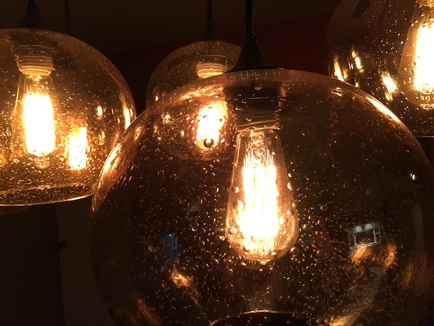 close-up of wet illuminated light bulbs