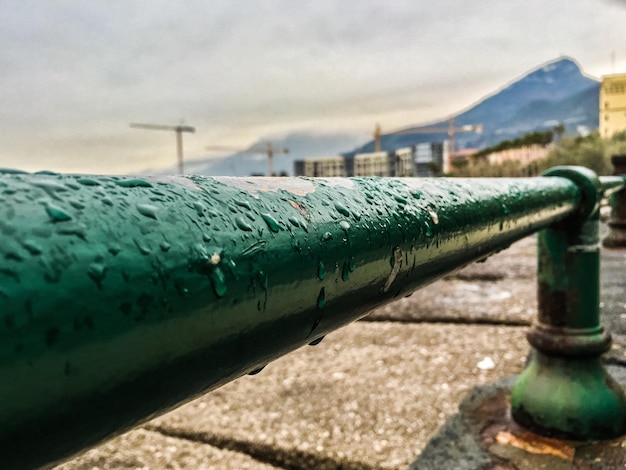 Close-up of wet railing during monsoon
