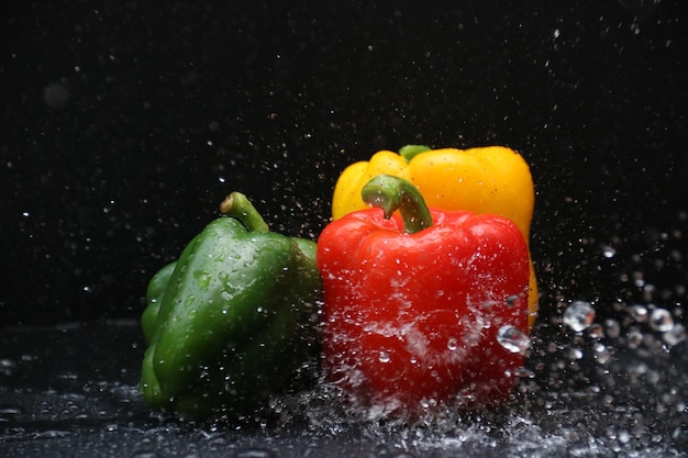 Close-up of wet red bell pepper against black background