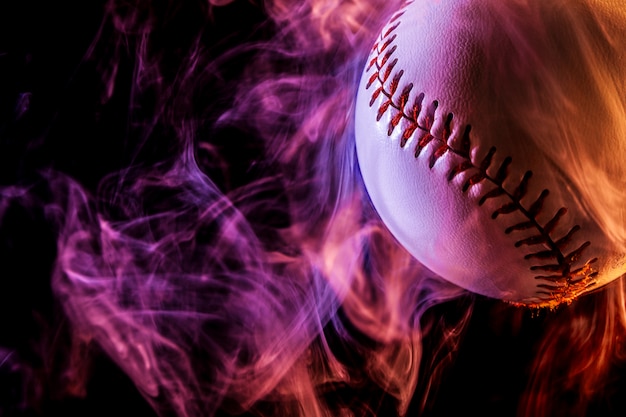 Close up of a white baseball ball in red smoke 