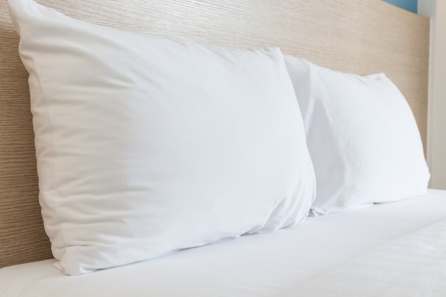 Close up white bedding sheets and pillow in hotel room