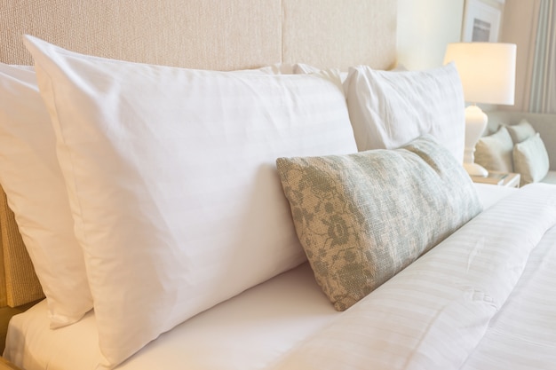 Close up white bedding sheets and pillow in hotel room