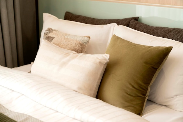 Close up white beige soft pillows on bed and blanket bedroom interior design conceptbed maid luxury ideas concept