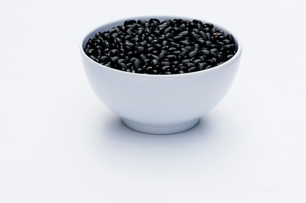 Close-up in white bowl with black beans isolated