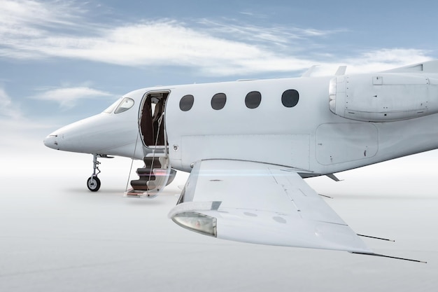 Close up of the white business jet with opened gangway door isolated on bright background with sky