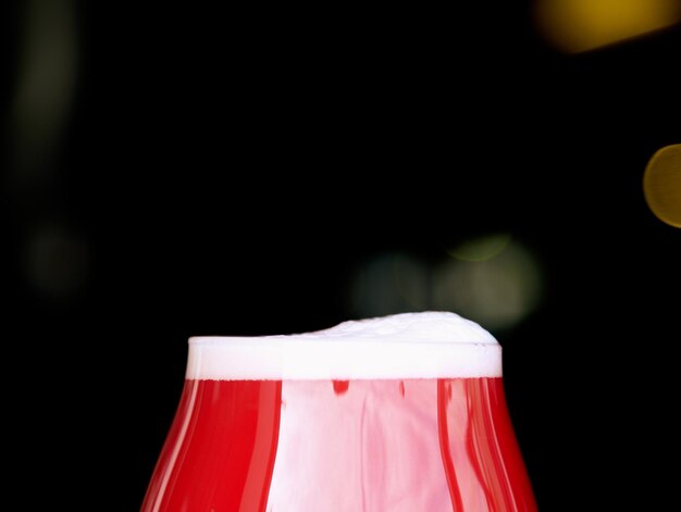 Close-up of white cake against black background