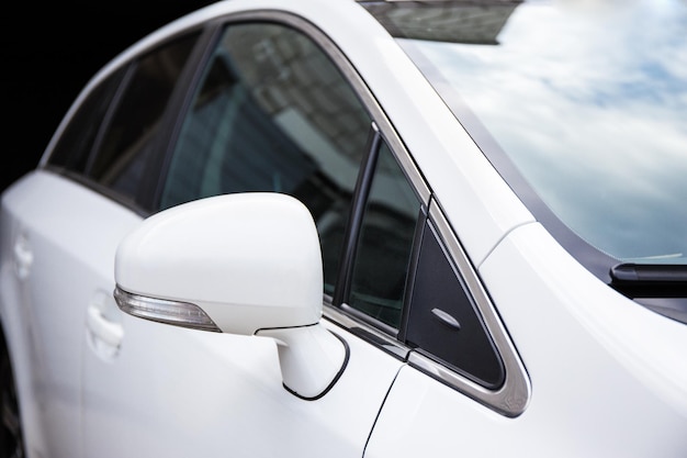 Close up of white car rear view mirror