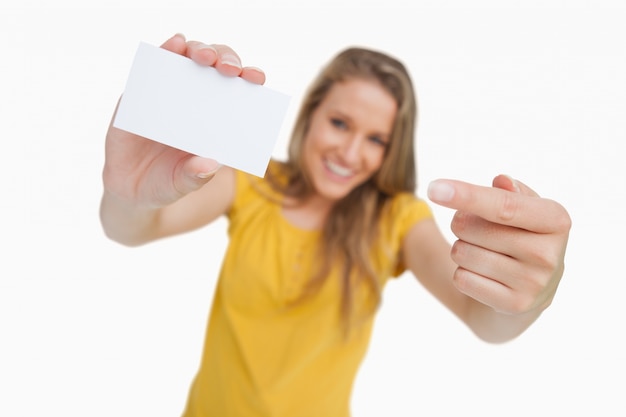 Photo close-up on a white card holding by a blonde student