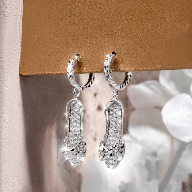 Close-up white gold stud earrings, with white crystals and diamonds. Women Accessories