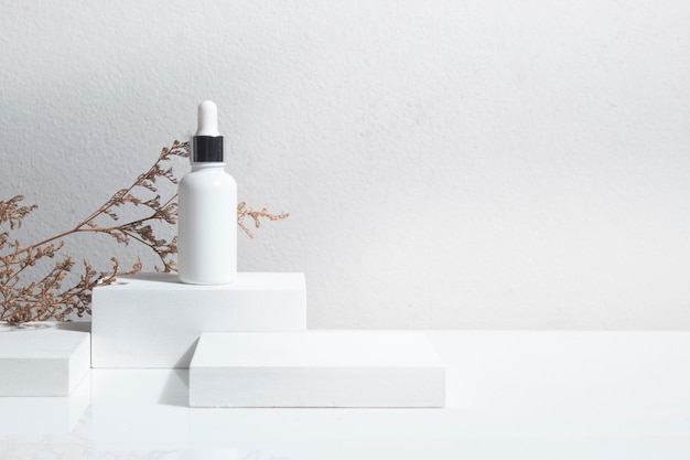 Close-up of white lamp on table against wall