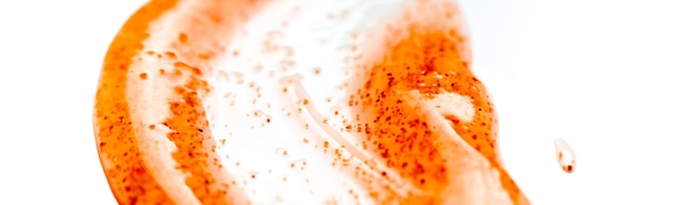 A close up of a white and orange bath cream