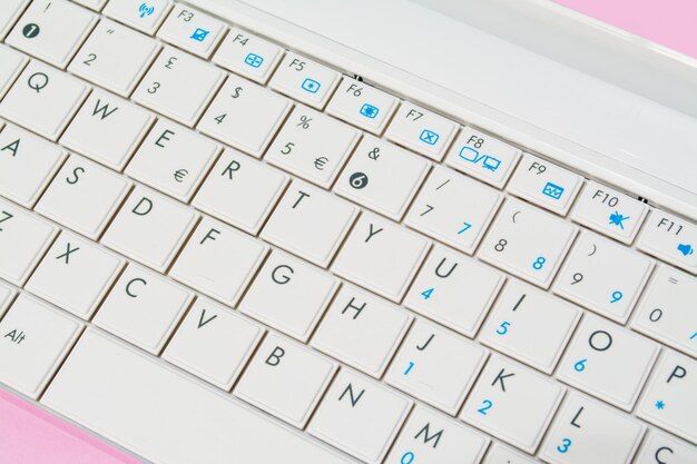 Close up of a white and pink laptop keyboard