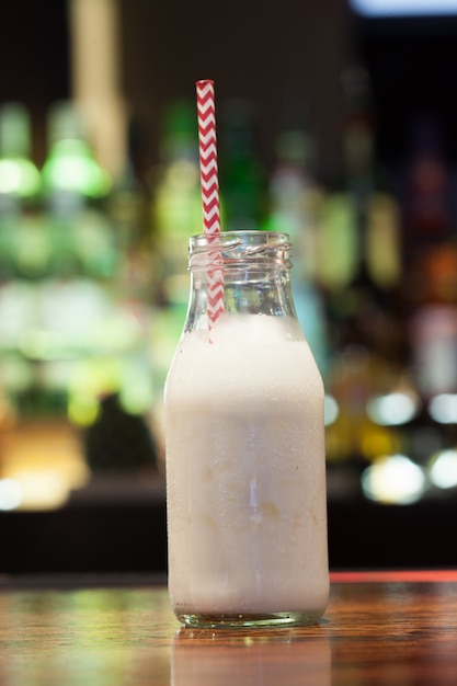 Close up on white russian with funny straw