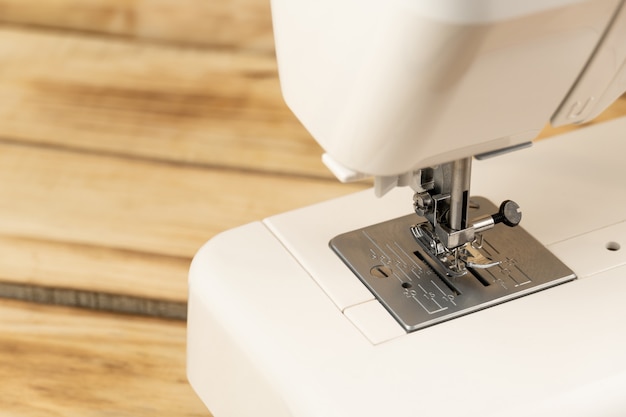 Close-up of a white sewing machine and sewing machine feet . sewing and needlework, sewing on a sewing machine.