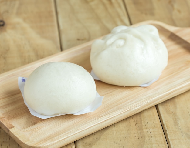 Close up white Steamed buns on wooden tray