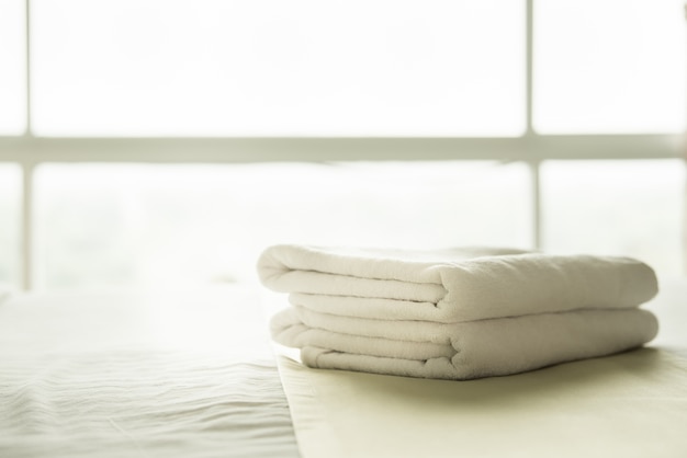 Close-up white towel on the bed