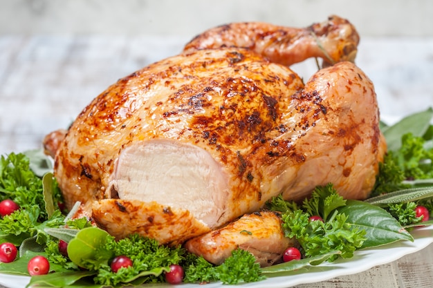 close up on whole roasted chicken with salad