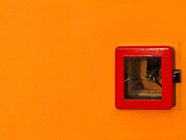 Close-up of window on orange wall