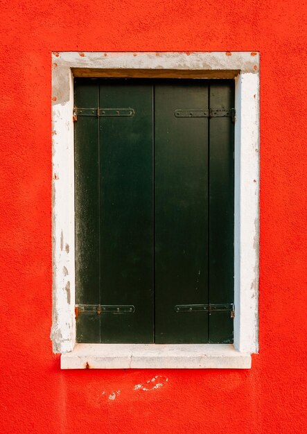 Close up of window on red housing wall