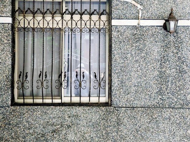 Close-up of window and wall lamp