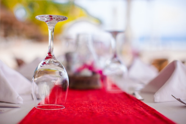 Close-up of wine glass on the set table for banquet at sunset