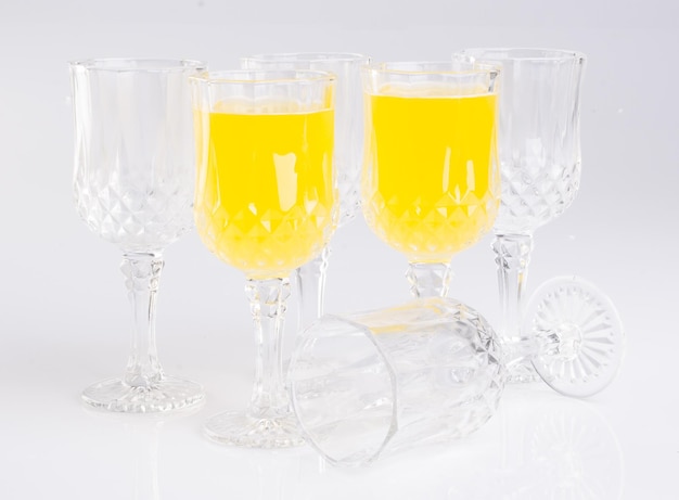 Photo close-up of wine glasses on table against white background