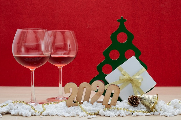 Close-up of wineglass by christmas decoration on table