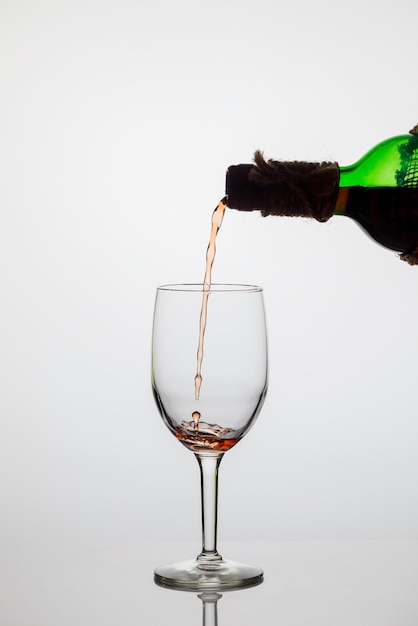 Photo close-up of wineglass on glass against white background