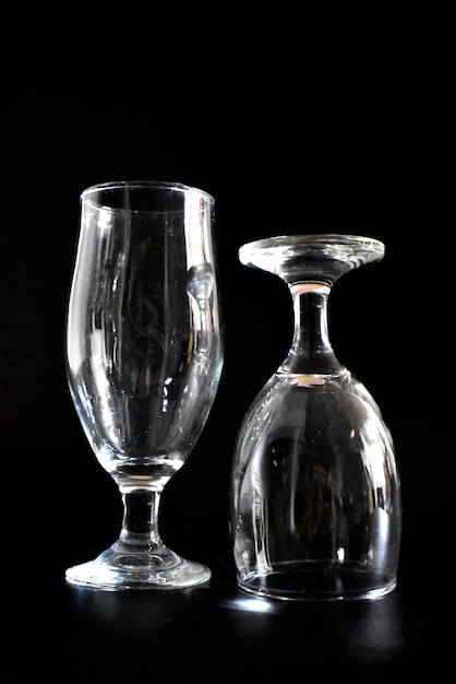 Photo close-up of wineglass on table against black background